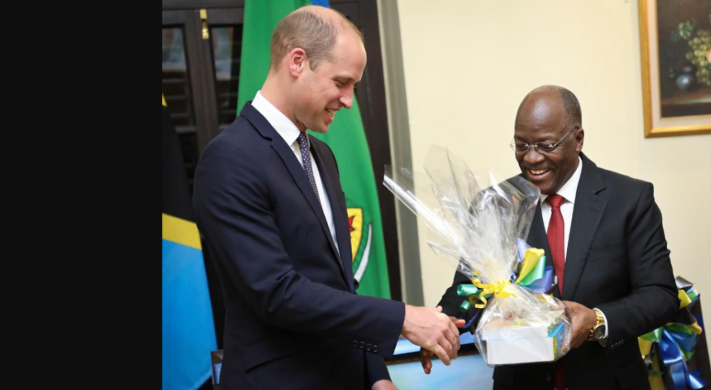Britain's Prince William, the Duke of Cambridge, left, receives a Swahili dictionary as a gift from Tanzania's President John Magufuli, right, at State House in Dar es Salaam, Tanzania, Thursday, Sept. 27, 2018. Britain's Prince William is in Africa this week to discuss threats to conservation ahead of a London conference on the illegal wildlife trade. (AP Photo/Khalfan Said) ASSOCIATED PRESS
